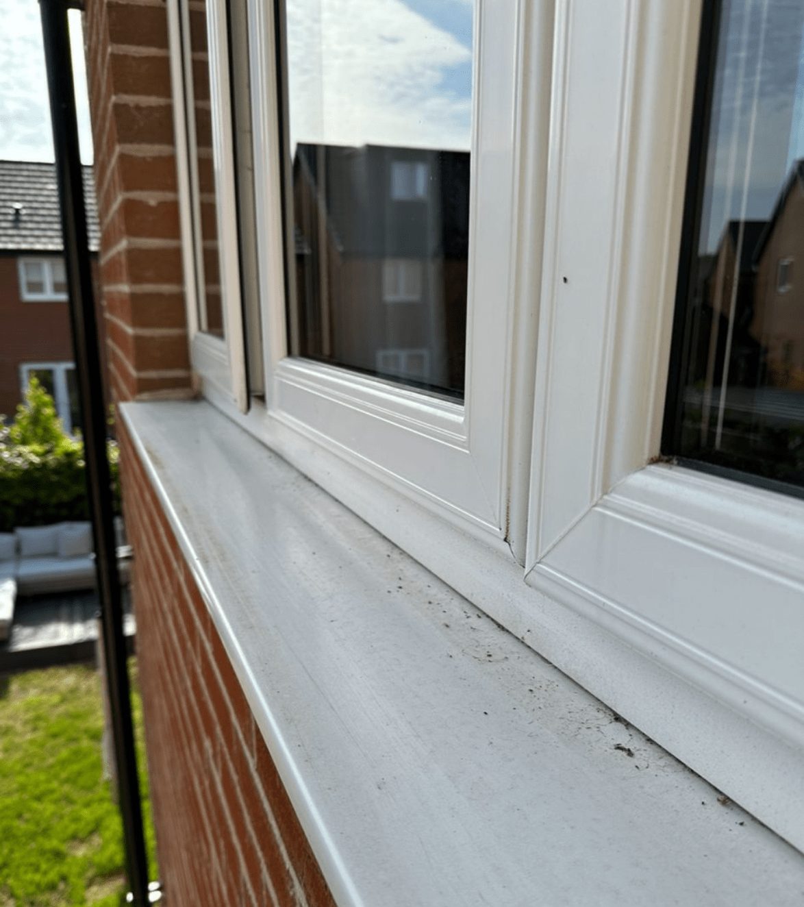 Photo of white house window before it's been sprayed